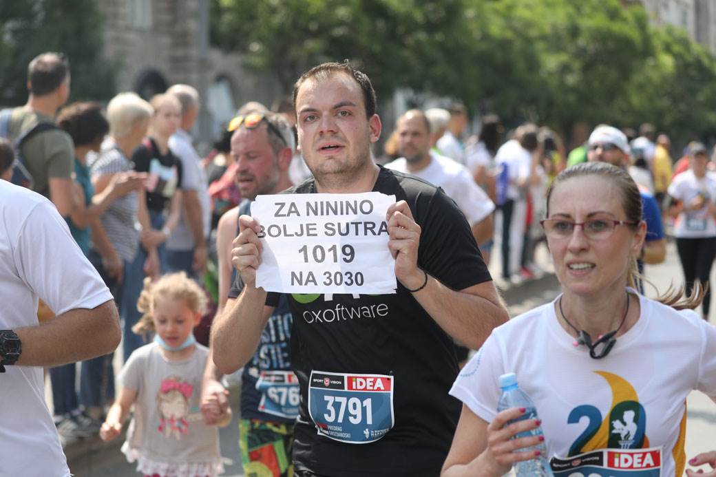 beogradski maraton trcao s bebom slep trkac maska na licu drzanje za ruke foto