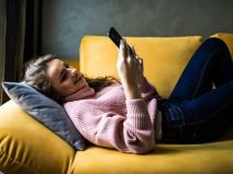 devojka igra igricu na telefonu