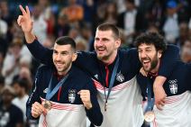 Nikola Jokić diže tri prsta dok slavi sa Dobrićem i Micićem.