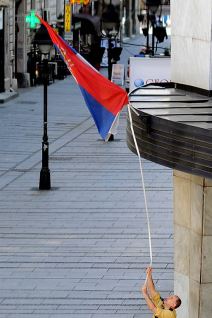 Zastava Srbije - Radnik isprvlja umotanu zastavu oko barjaka