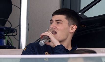 Andrija Maksimović grize flašicu vode.