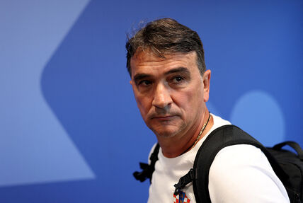 Zlatko Dalić u beloj majici na plavoj pozadini.