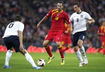 Montenegro's Dejan Damjanovic (C) runs with the ball in front of England's Frank Lampard (R) during the World Cup 2014 Group H Qualifying football match between England and Montenegro at Wembley Stadium in north London on October 11, 2013.,Image: 174409119, License: Rights-managed, Restrictions: NOT FOR MARKETING OR ADVERTISING USE / RESTRICTED TO EDITORIAL USE, Model Release: no