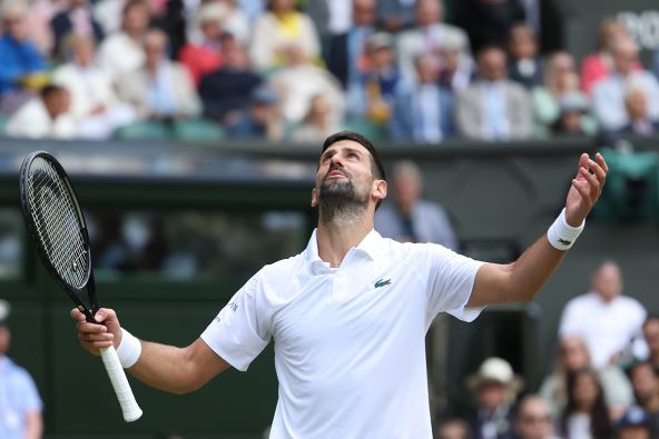 Novak Đoković na Vimbldonu diže ruke u vazduh.